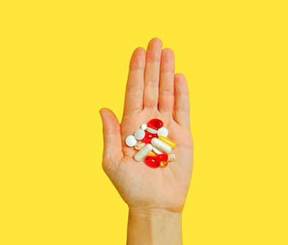 Person hand's filled with pills