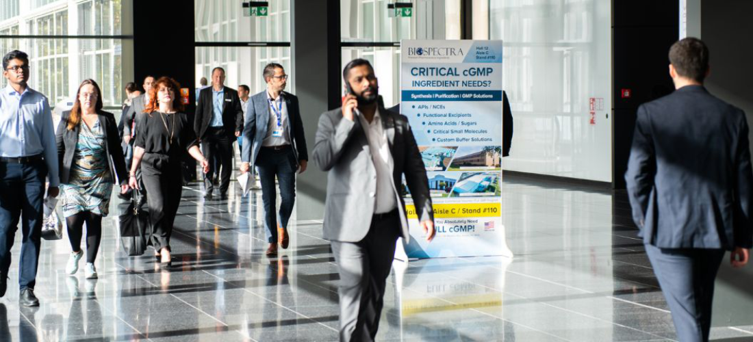 Male on mobile phone walking through exhibition hall