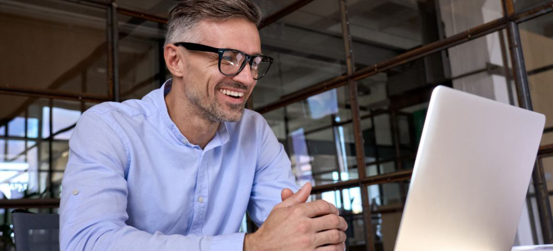 Male professional in shirt using laptop