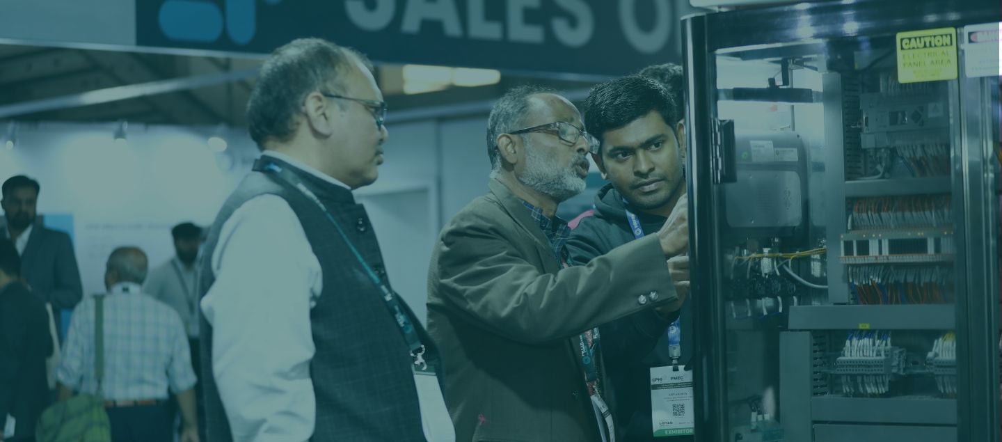 Pharma exhibitor showcasing product to professionals at CPHI event