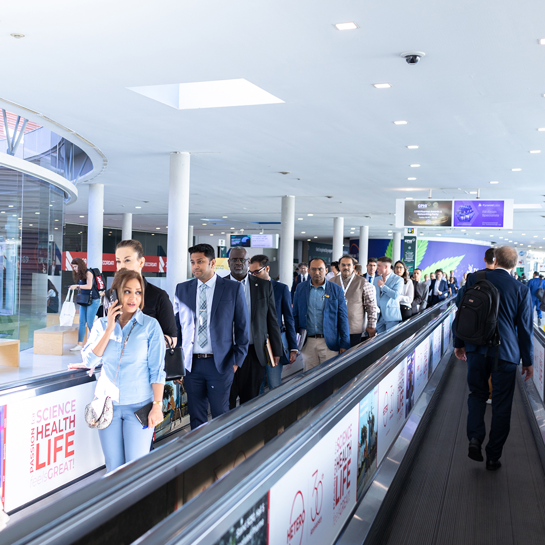 pharma professionals on moving walkway at CPHI event