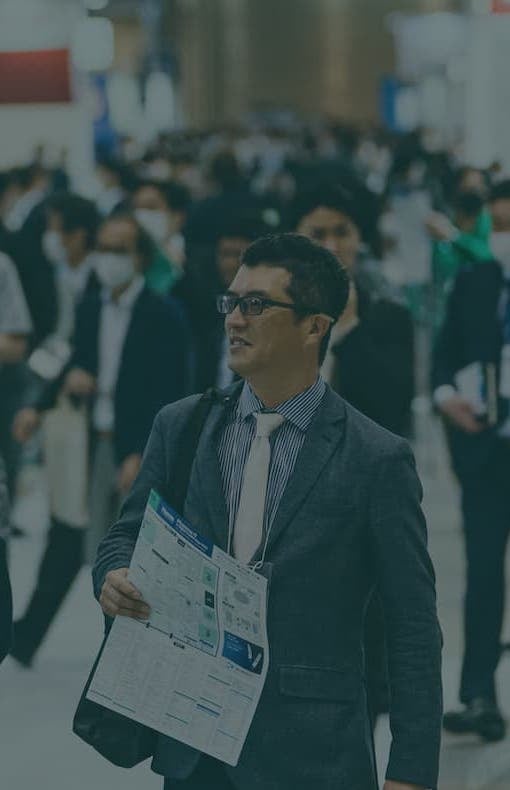 Male professional with map at CPHI Japan exhibition hall