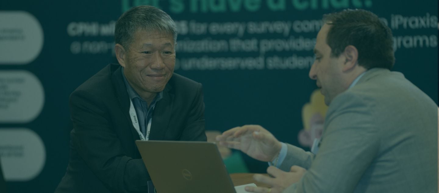 Pharma professional showing individual work on a laptop at CPHI North America