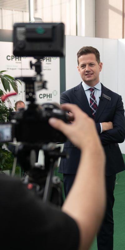 male professional in front of camera at CPHI event