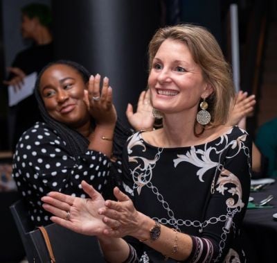 female professional applauding at CPHI event