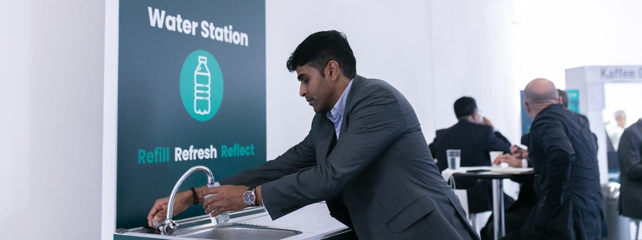 Male professional washing hands at CPHI event