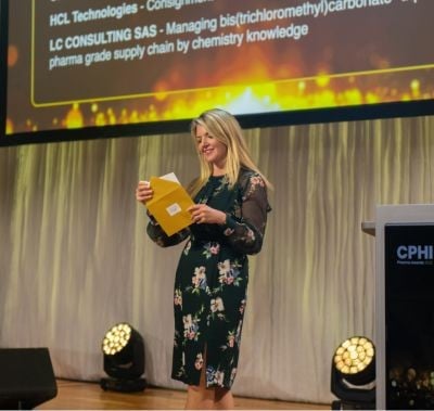 Female reading the nomination winner on stage at CPHI Awards