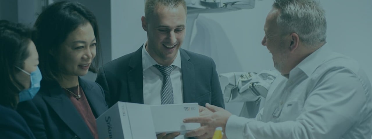 Pharma professional showcasing product to buyer