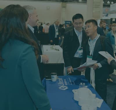 pharma professionals at exhibition table